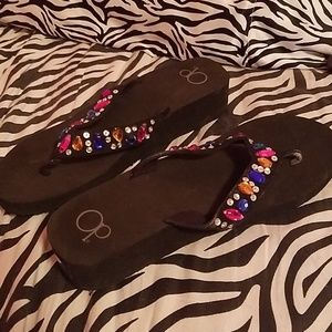 Black jewel encrusted flip flops